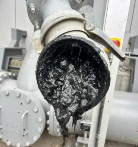 Viscous sludge comes out of a pipe